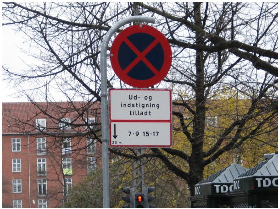 Skilt der viser betinget standsningsforbud, hvor kun ud- og indstigning er tilladt.